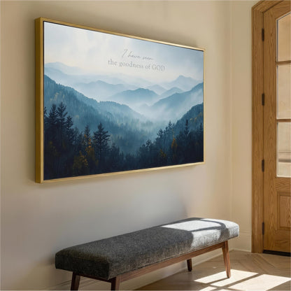 a large framed painting of a mountain landscape hanging on a wall, with a bench in the foreground.
