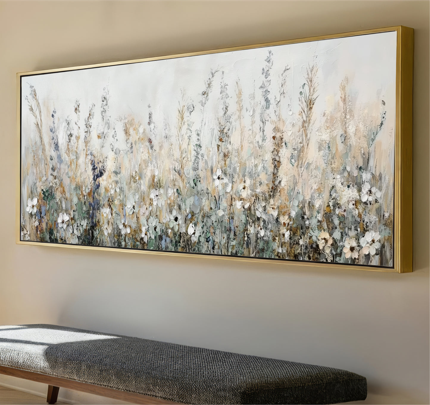 a large, framed painting of a field of flowers hanging on a wall.