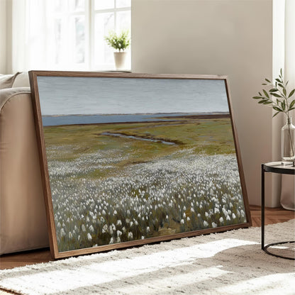 a large framed painting depicting a field of white flowers, with a body of water in the background.