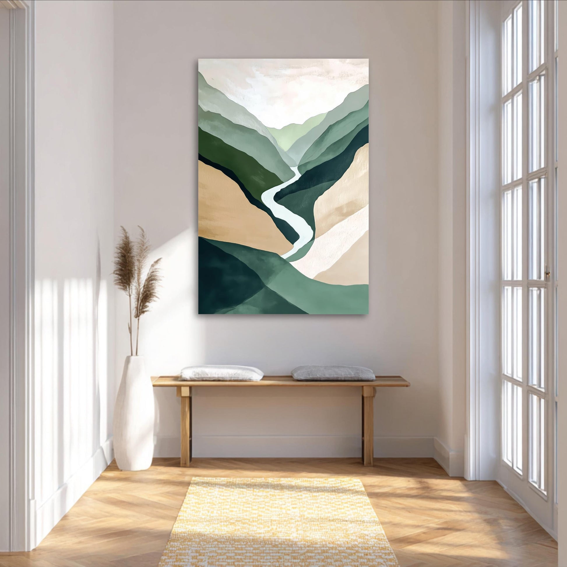 a large abstract painting of mountains and a winding river hanging on a white wall in a bright, airy room with a wooden bench and a potted plant.