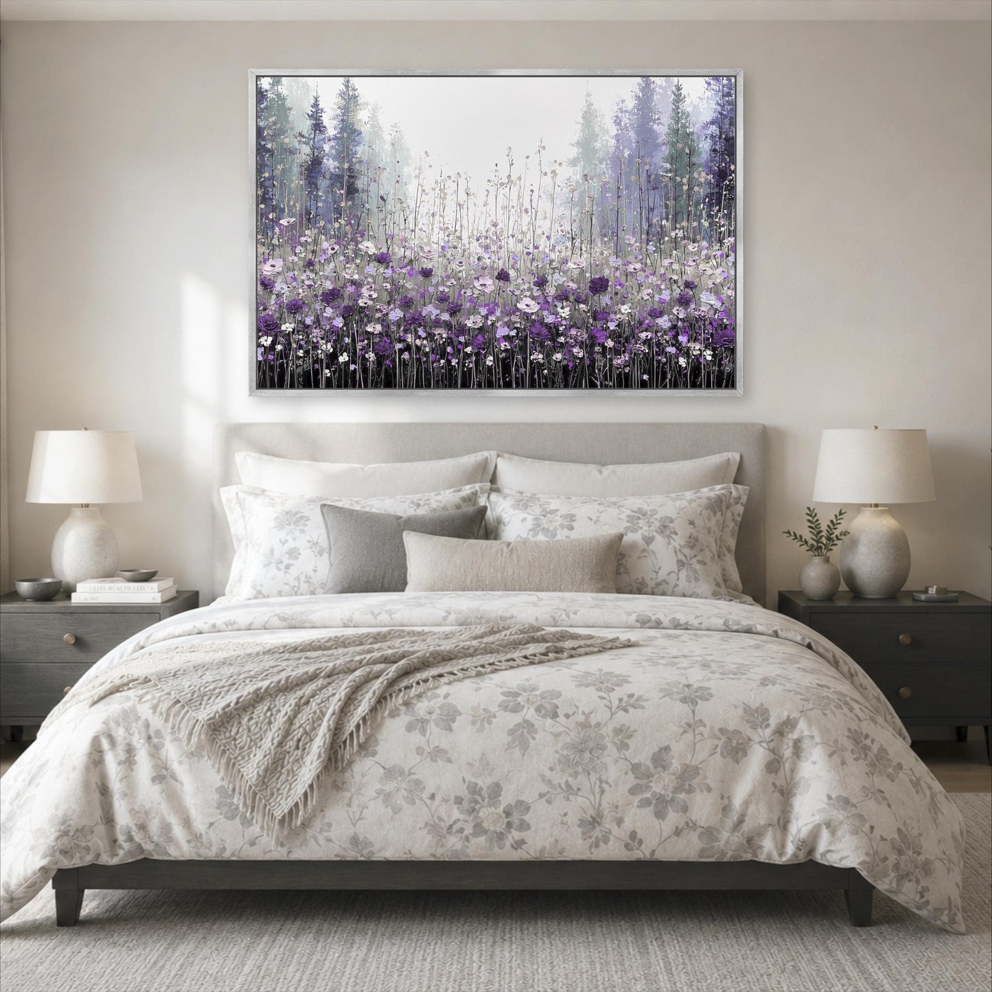 a serene bedroom scene with a large bed adorned with a floral comforter and pillows, flanked by two nightstands with lamps. Above the bed, a large framed painting of a field of purple flowers is displayed on the wall, creating a calming and peaceful atmosphere in the room.