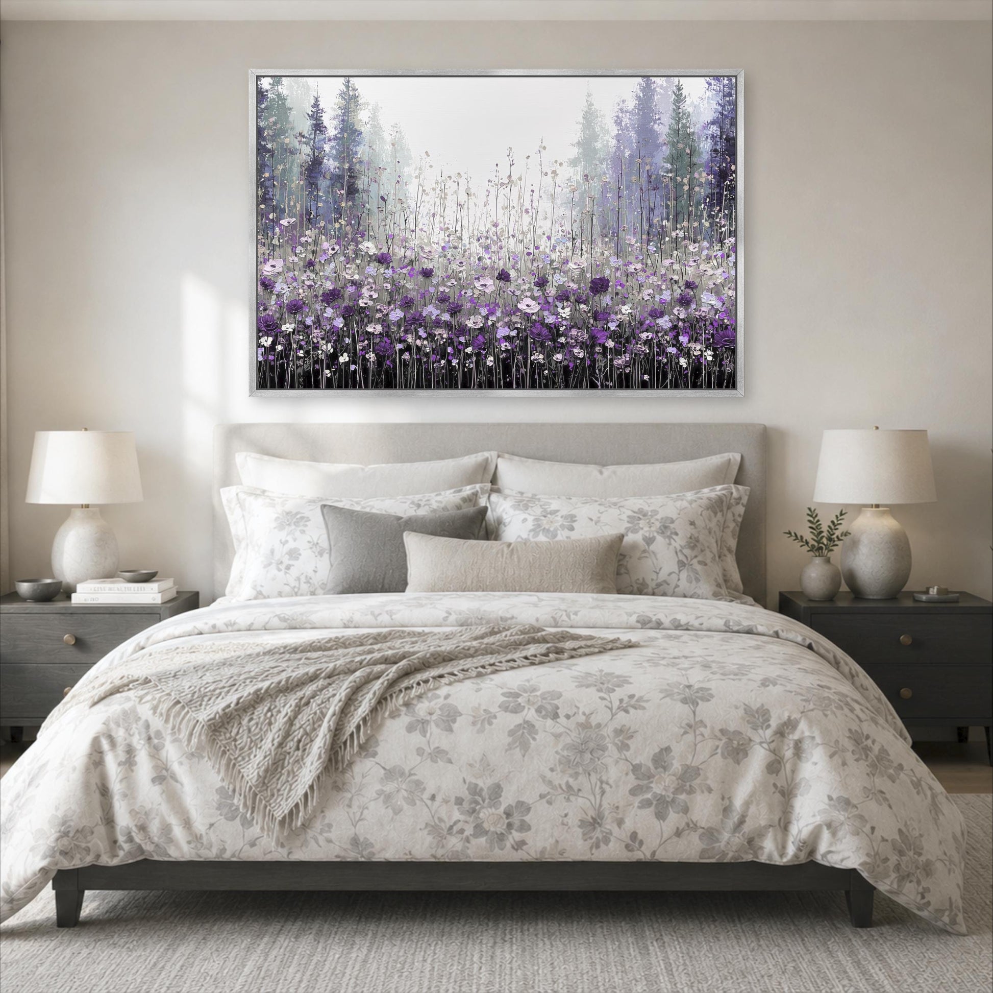a serene bedroom scene with a large bed adorned with a floral comforter and pillows, flanked by two nightstands with lamps. Above the bed, a large framed painting of a field of purple flowers is displayed on the wall, creating a calming and peaceful atmosphere in the room.