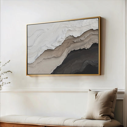a large abstract painting hanging on a white wall above a wooden bench with a beige pillow.