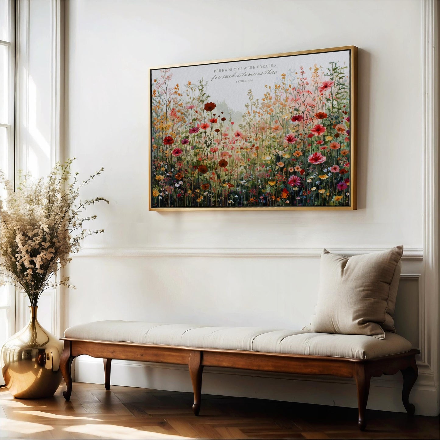 a large, colorful painting of a field of flowers hanging on a white wall above a wooden bench.