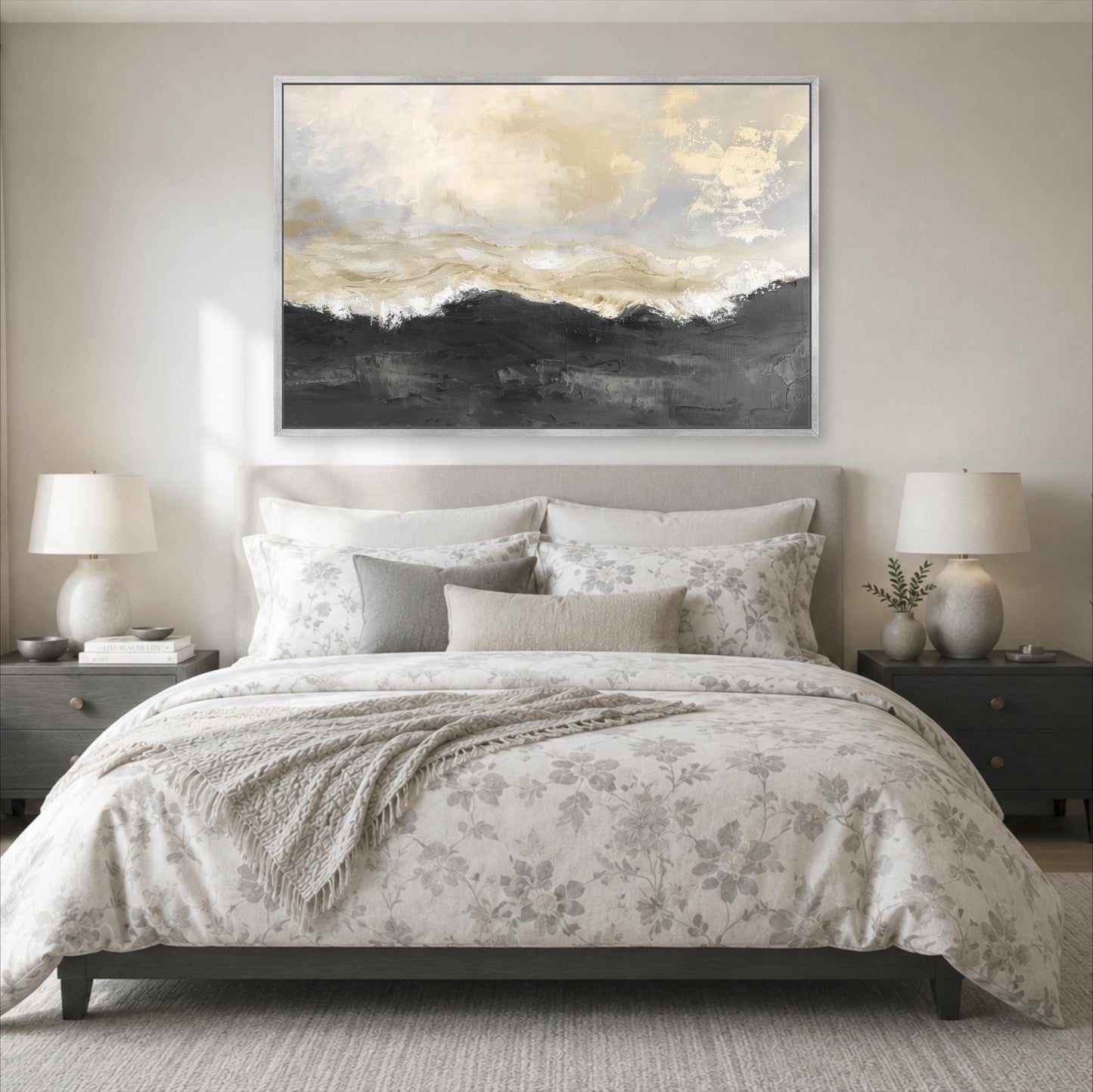a serene and elegant bedroom with a large bed adorned with a floral comforter and pillows. Above the bed, a large painting of a landscape with a cloudy sky and mountains is displayed on the wall. The room is decorated with two nightstands, each with a lamp, and a rug on the floor.