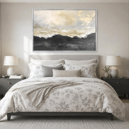 a serene and elegant bedroom with a large bed adorned with a floral comforter and pillows. Above the bed, a large painting of a landscape with a cloudy sky and mountains is displayed on the wall. The room is decorated with two nightstands, each with a lamp, and a rug on the floor.