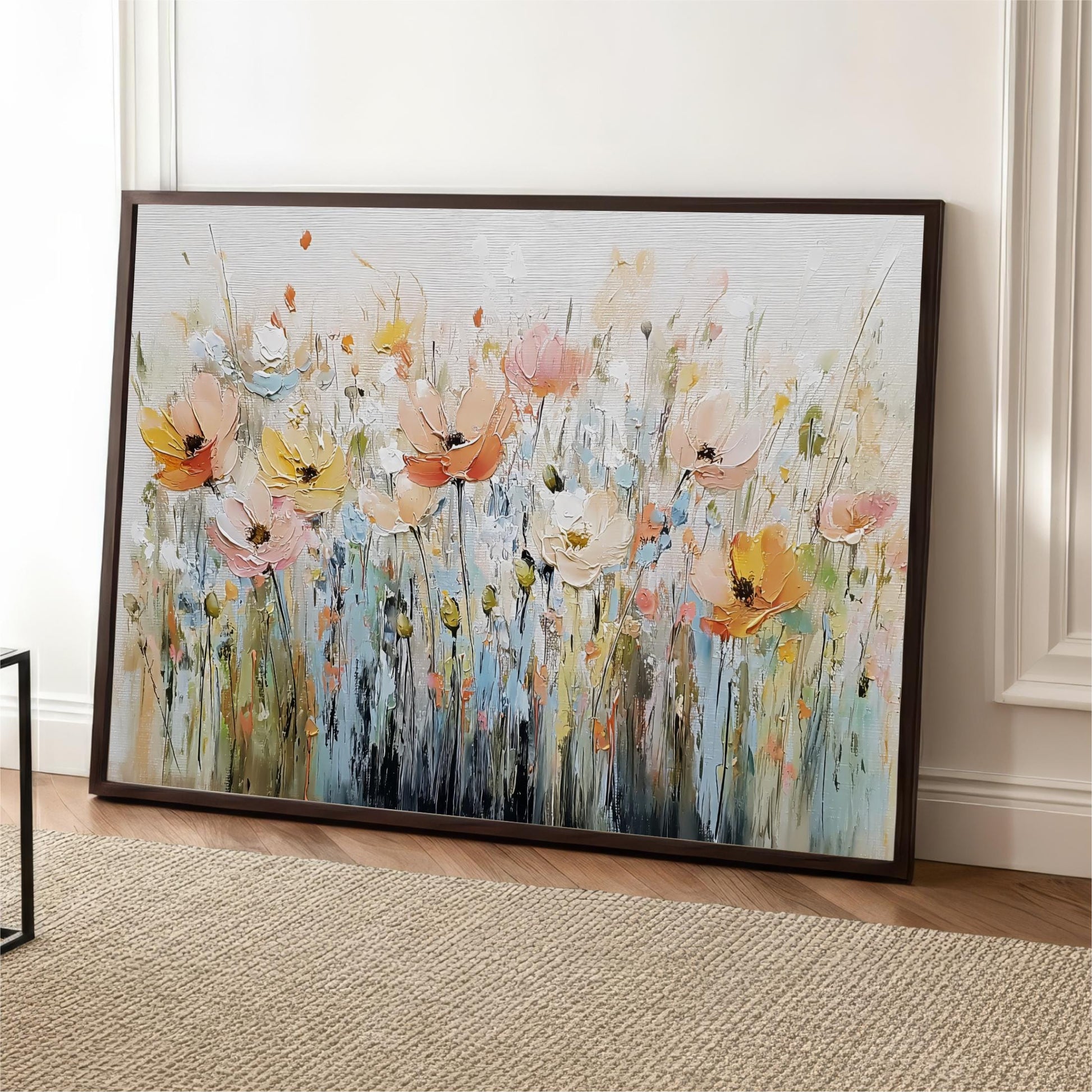 a large, framed painting of a field of colorful flowers, including pink, orange, and yellow blooms, set against a white background.