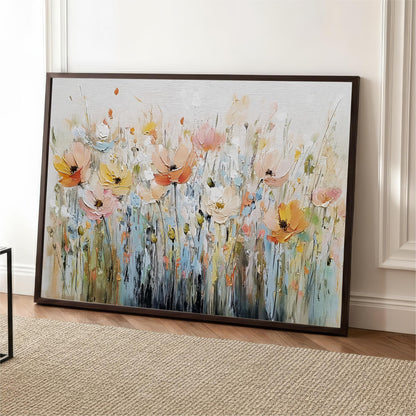 a large, framed painting of a field of colorful flowers, including pink, orange, and yellow blooms, set against a white background.