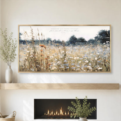 a large framed painting of a field with flowers hanging above a fireplace.