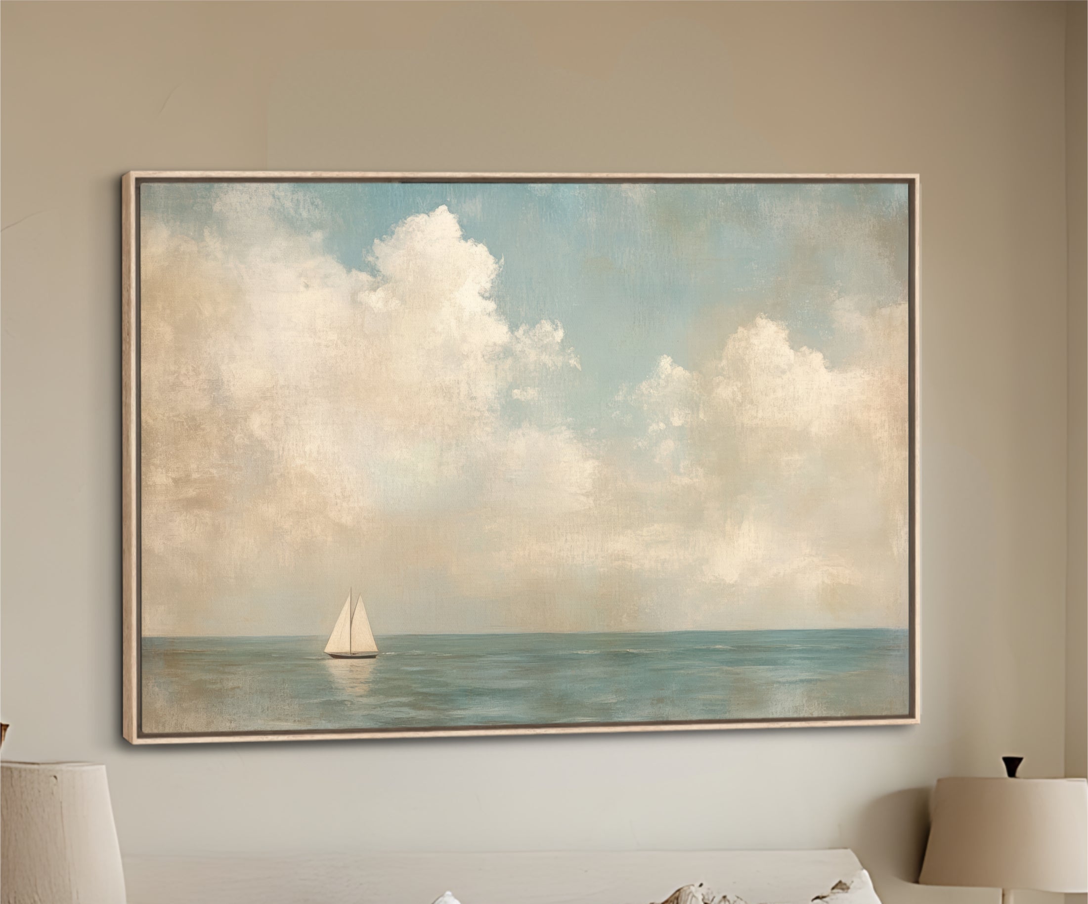 Framed artwork of a sailboat on an ocean with clouds above, hanging on a wall above a sofa.