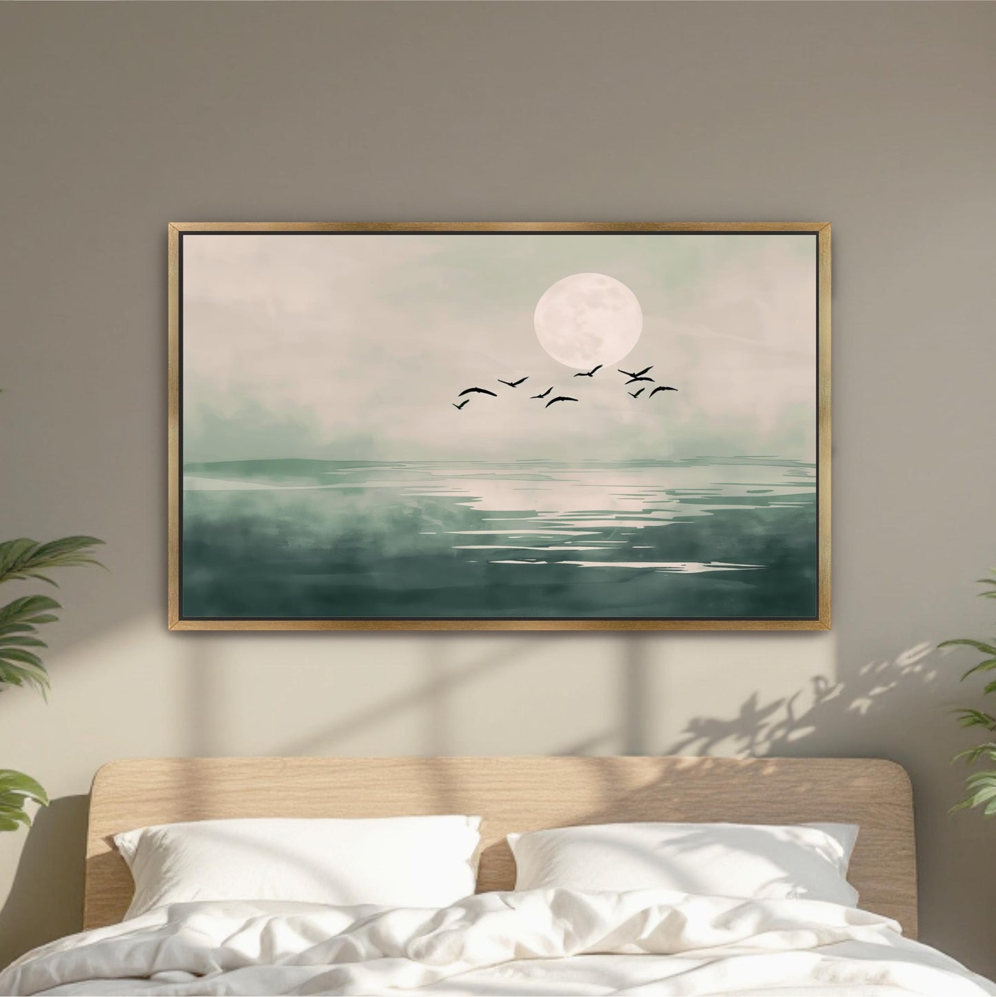 a large framed painting of a serene landscape with a full moon, birds flying over a body of water.
