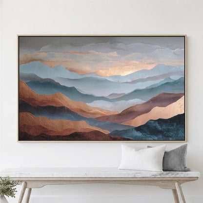a large framed painting of mountains with a warm, golden glow, hanging on a white wall above a wooden bench with two pillows.