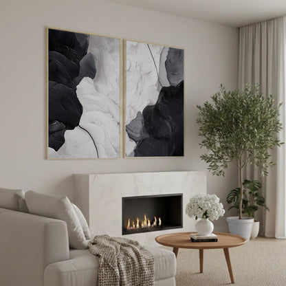 a cozy living room with a fireplace, a comfortable sofa, and a coffee table with a vase of white flowers. The room has a minimalist and modern design, with a large abstract painting on the wall and a potted plant adding a touch of greenery.