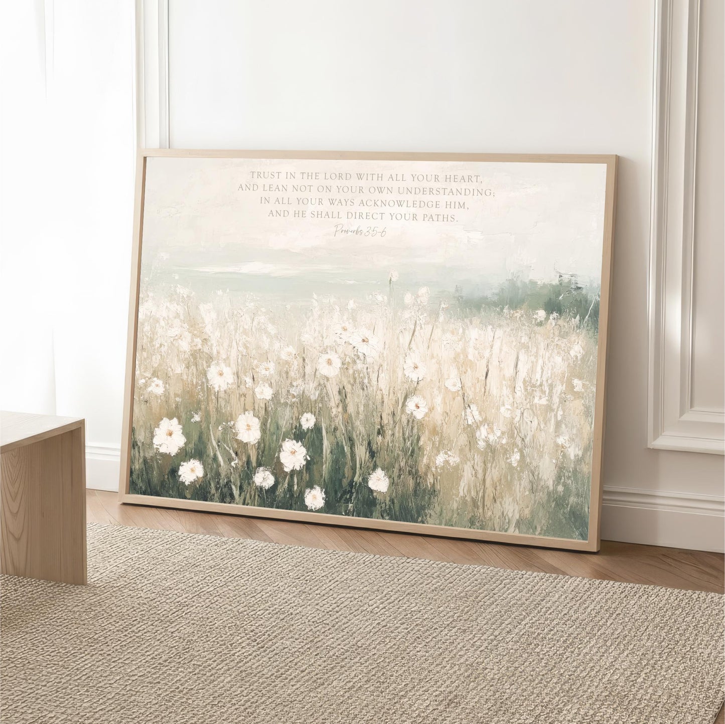 A framed painting depicting a field of white flowers against a pale blue sky, with a text overlay that reads "Trust in the Lord with all your heart, and lean not on your own understanding, in all your ways acknowledge Him, and be known to direct your paths."