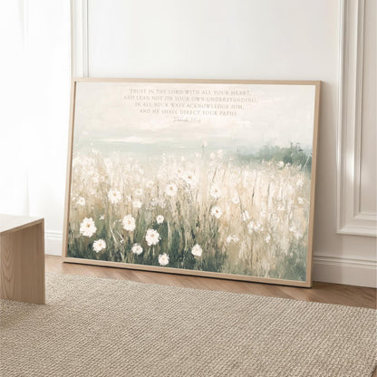 A framed painting depicting a field of white flowers against a pale blue sky, with a text overlay that reads "Trust in the Lord with all your heart, and lean not on your own understanding, in all your ways acknowledge Him, and be known to direct your paths."