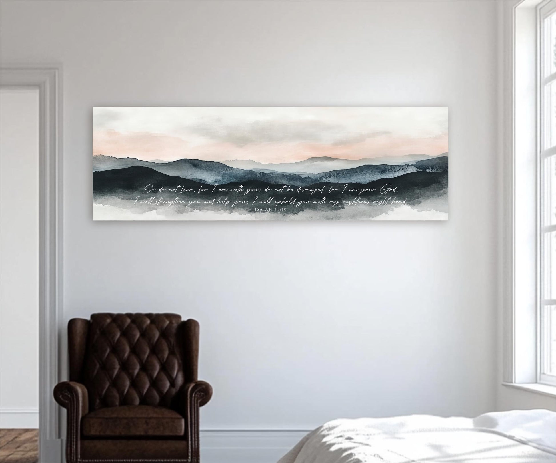 a large, rectangular, abstract landscape painting hanging on a white wall in a room. Below the painting, there is a brown leather armchair.