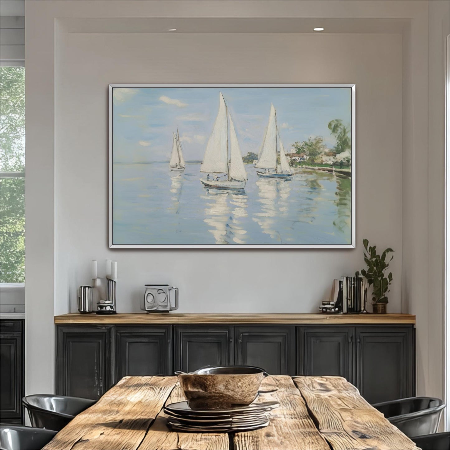 a large painting of three sailboats on a calm body of water, hanging on a wall above a wooden dining table.