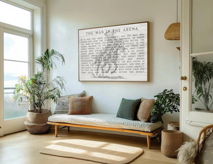 a serene and cozy living room with a large framed quote on the wall, a comfortable sofa with throw pillows, and several potted plants.