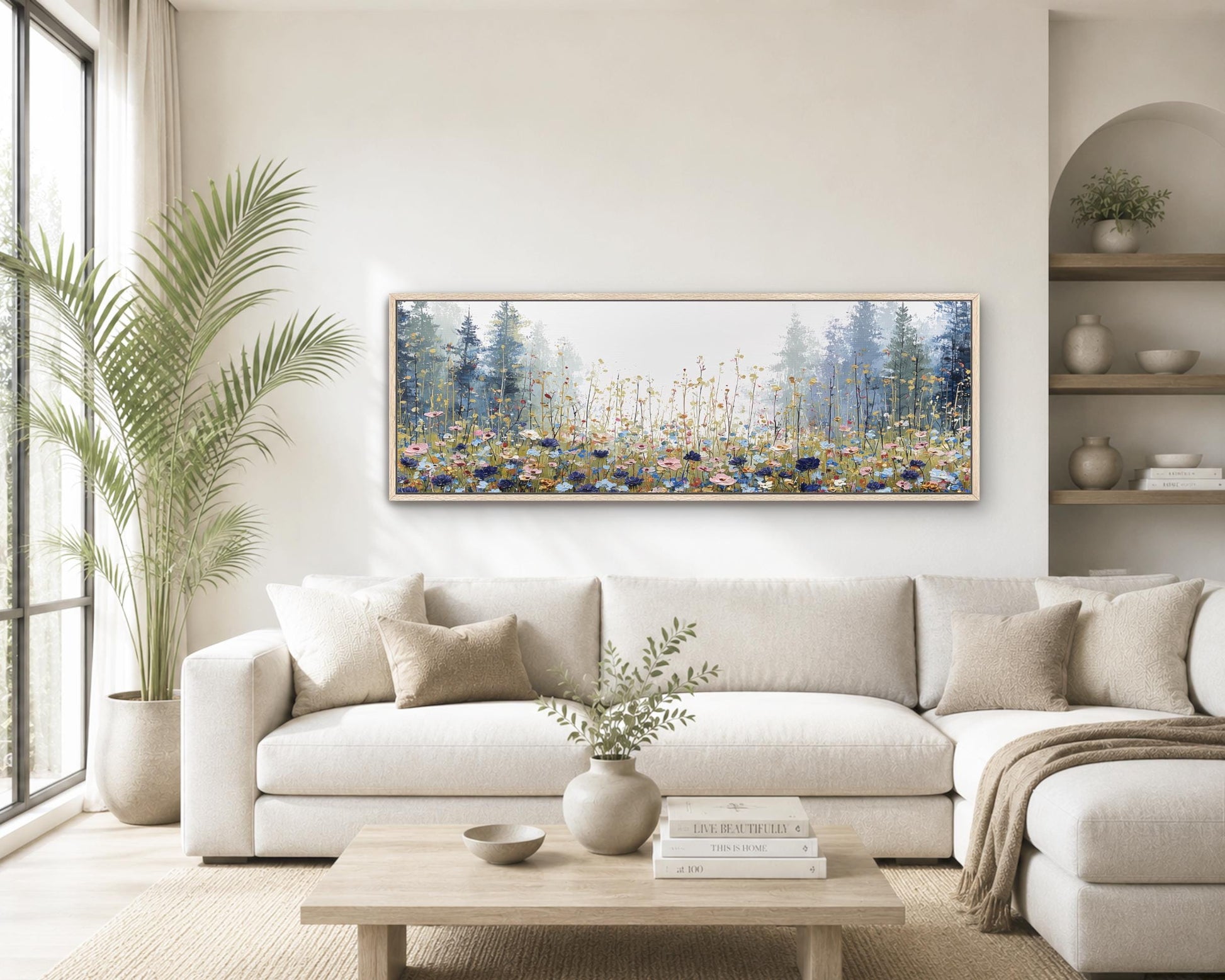a cozy living room with a large, framed painting of a forest scene hanging on the wall above a white sofa. The room is decorated with various plants, vases, and books, creating a warm and inviting atmosphere.
