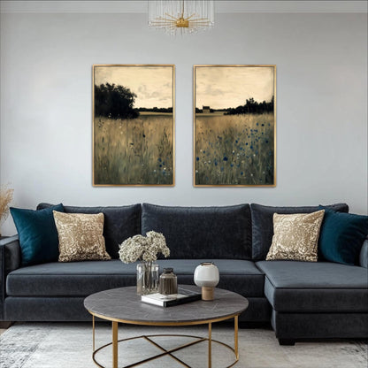 a living room with a gray sectional sofa, a round coffee table, and two framed landscape paintings hanging on the wall above the sofa.