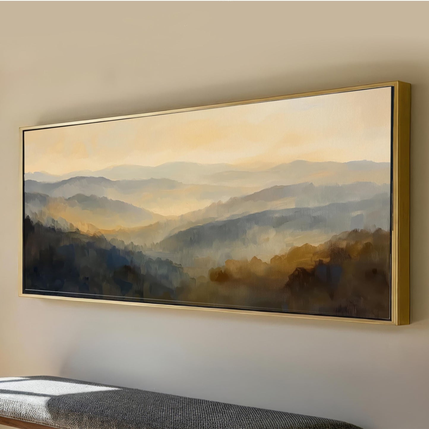 a large landscape painting hanging on a wall, depicting a scenic mountain range with a hazy, golden-hued sky.