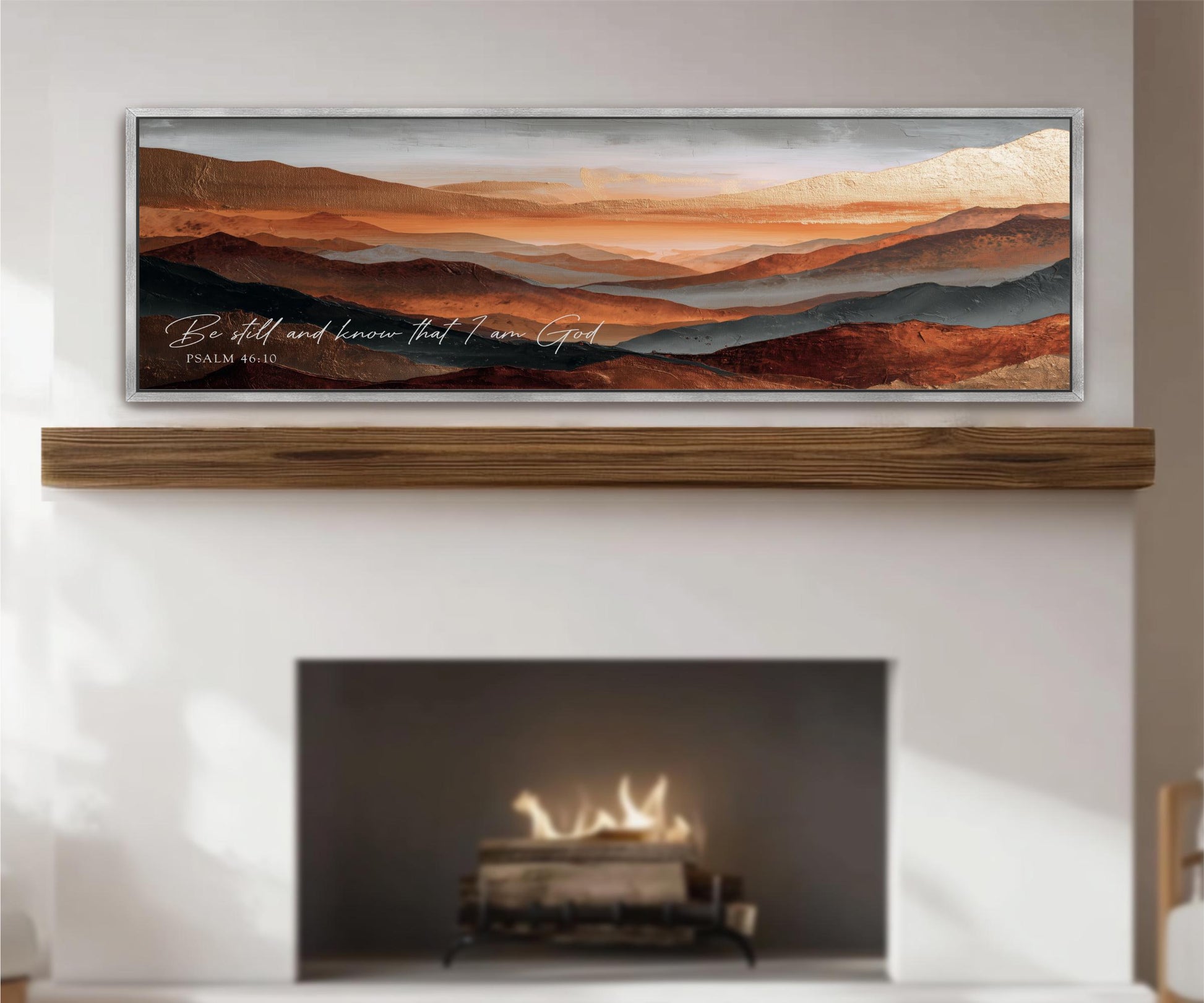 a fireplace with a warm fire burning inside, and above it is a framed landscape painting depicting a mountainous, desert-like scene with a warm, orange and red color palette.