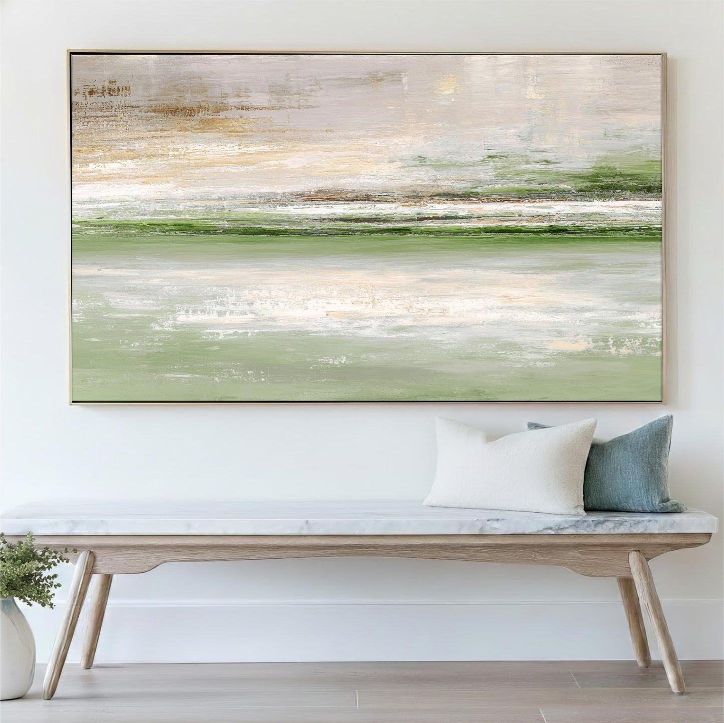 a large abstract painting hanging on a white wall above a wooden bench with a white cushion.