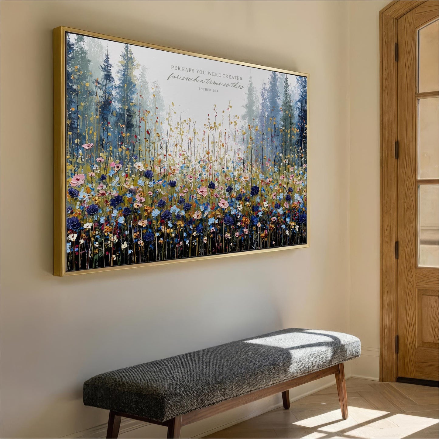 a large, colorful painting of a field of flowers hanging on a wall. The painting is framed in gold and is the main focus of the room. In front of the painting, there is a gray bench, and a wooden door can be seen on the right side of the image.
