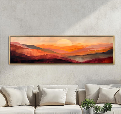 a large, rectangular painting of a sunset over mountains hanging on a wall above a couch.