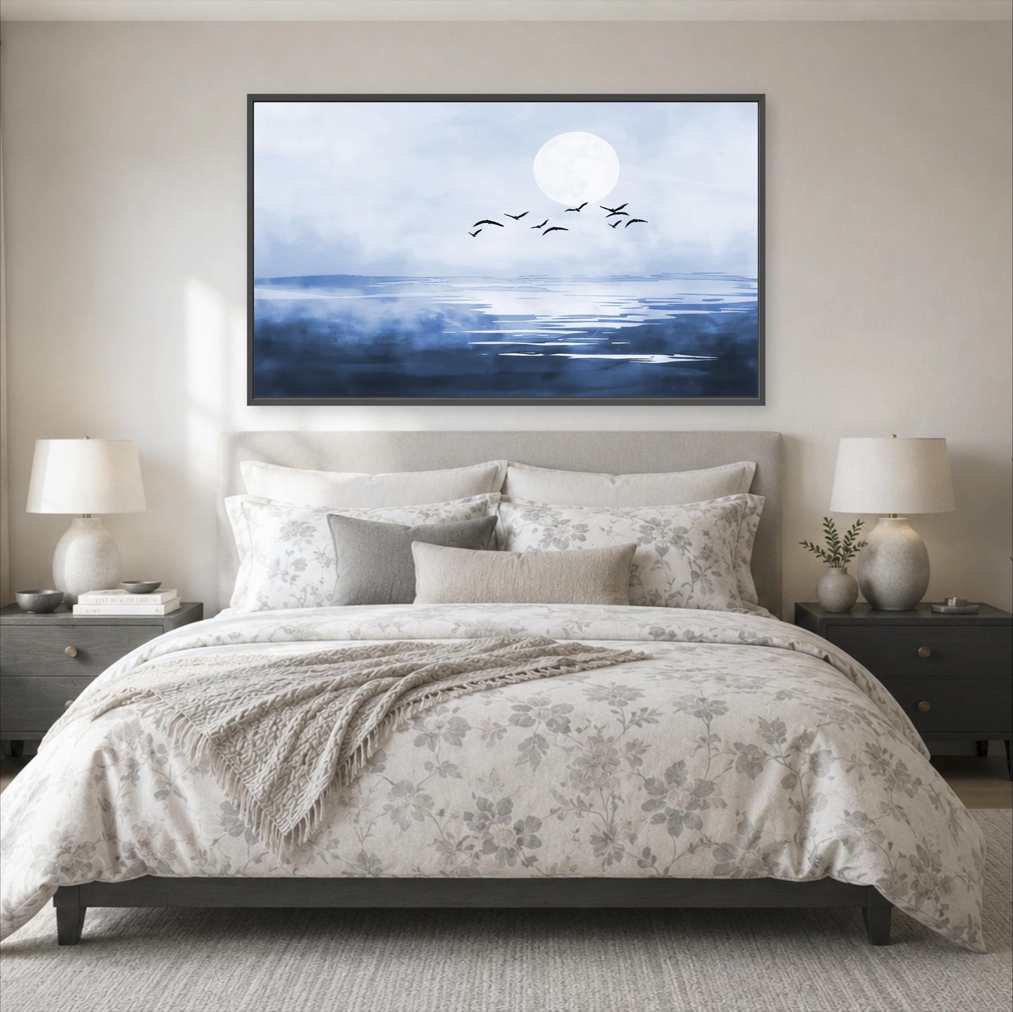 a serene bedroom scene with a large bed, a nightstand on each side, and a framed painting of a tranquil ocean landscape above the bed.