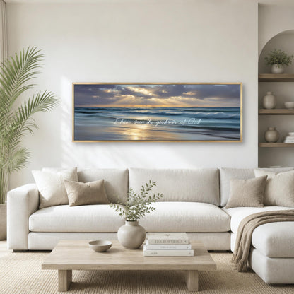 a large framed painting of a serene beach scene with a sunset over the ocean, hanging on a white wall above a white sofa in a living room.