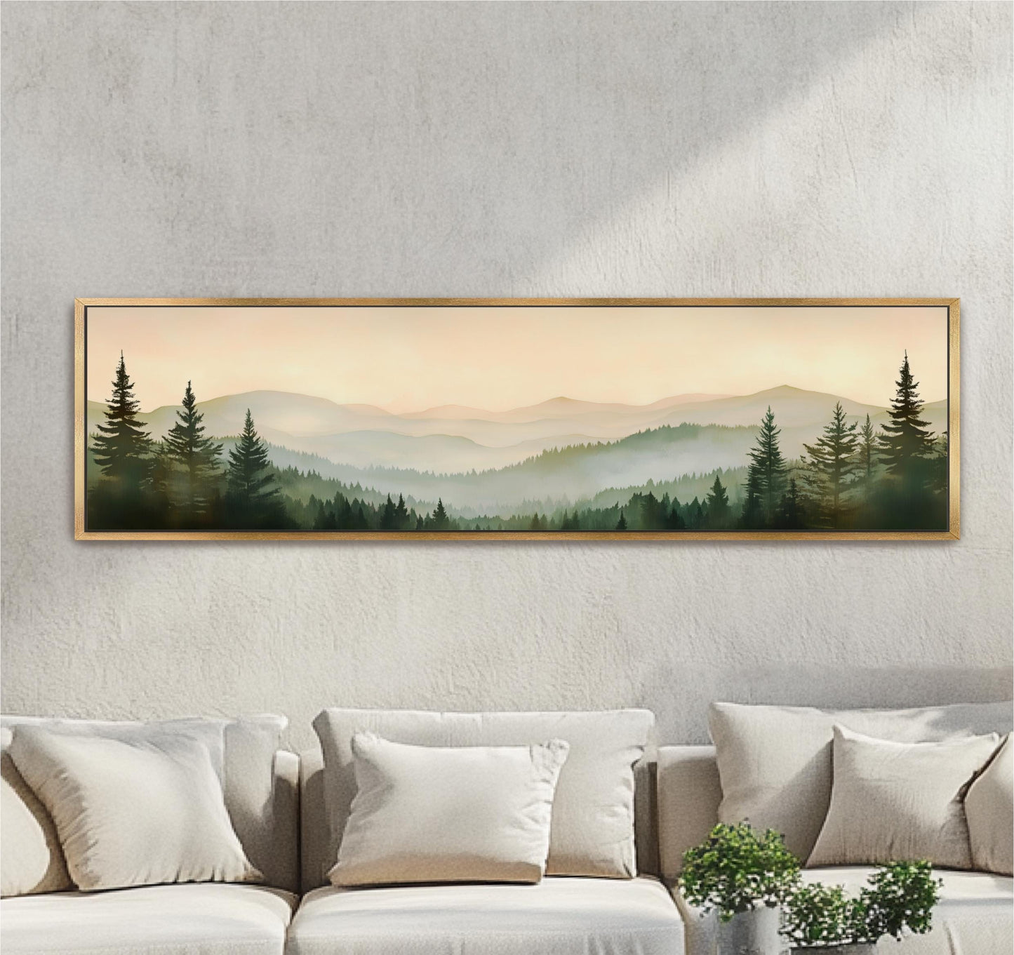 a large framed landscape painting hanging on a wall above a couch with white pillows.