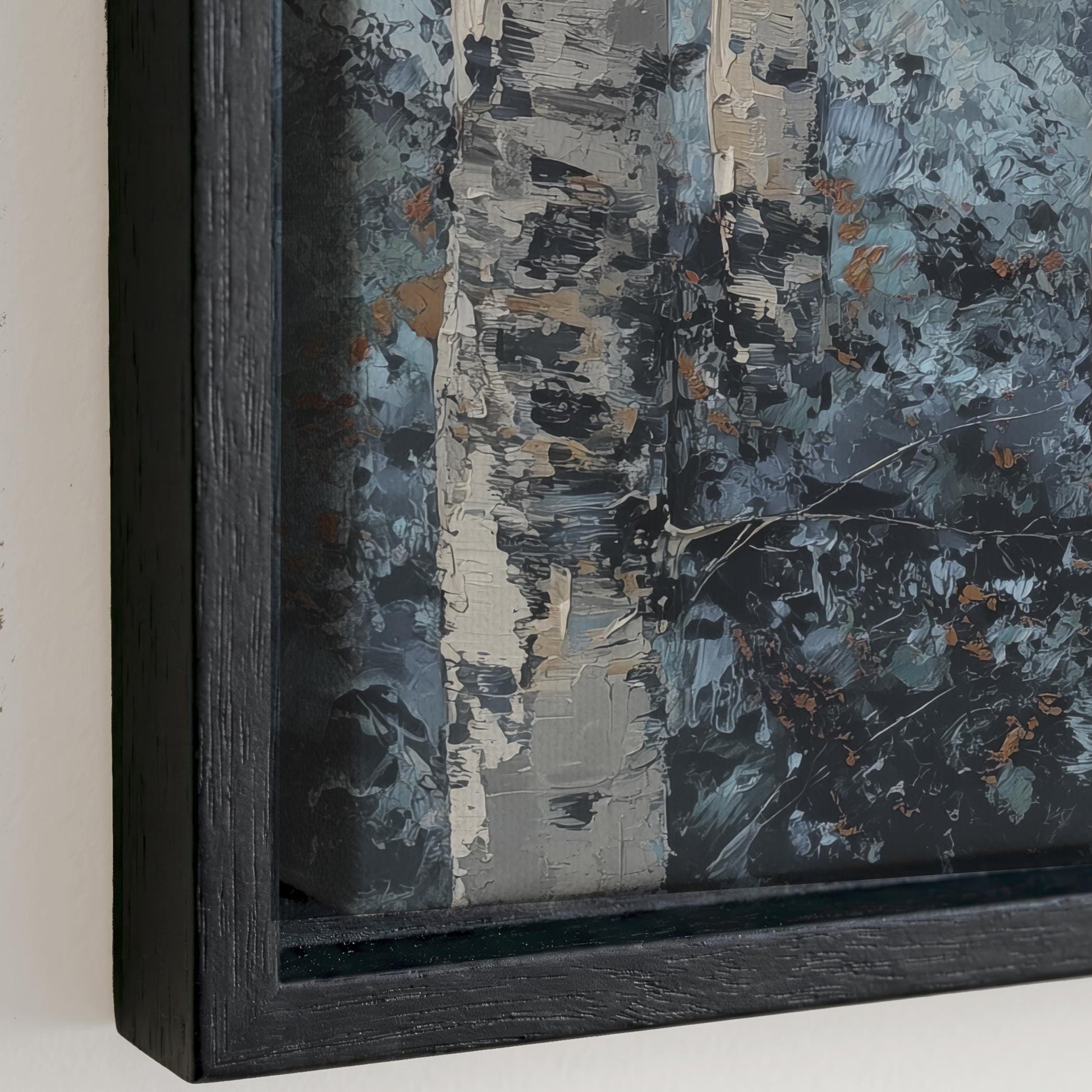 The image is a close-up of a framed painting depicting a forest scene with a mix of dark and light colors, including shades of blue, gray, and brown.