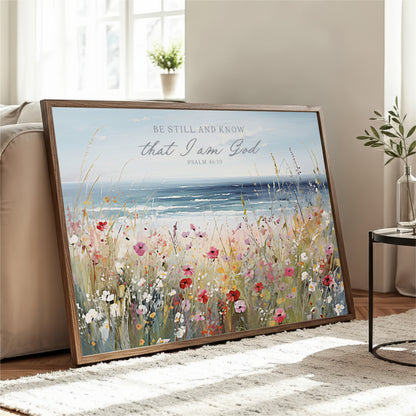 A framed painting depicting a serene landscape with a field of colorful flowers and a body of water, accompanied by a Bible verse from Psalm 46:10.