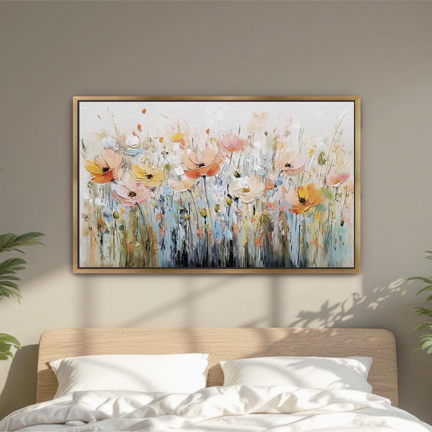 a large, colorful painting of flowers hanging on a wall above a bed with white pillows.