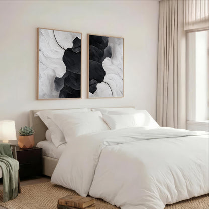 a serene and modern bedroom with a large bed, white bedding, and two abstract paintings hanging above it.