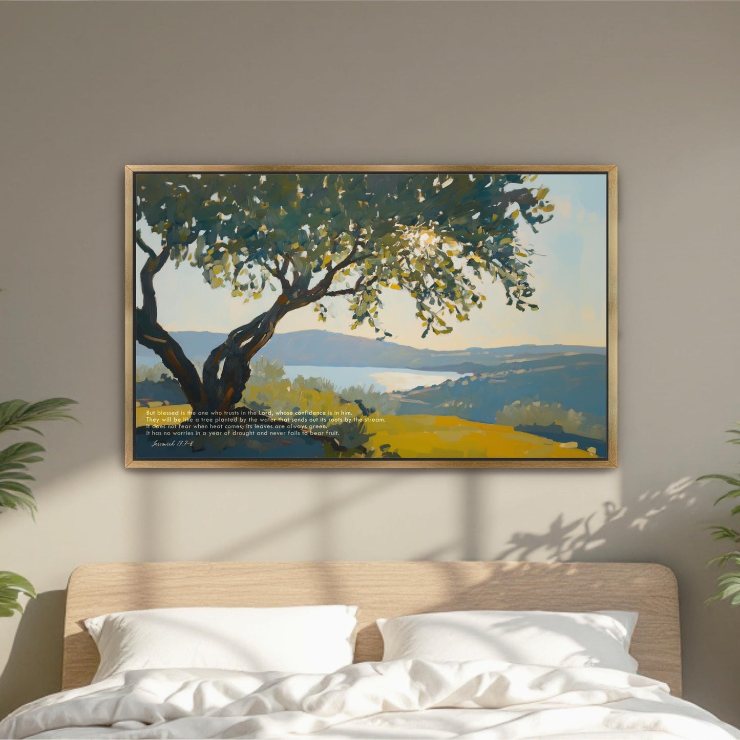 a large painting of a tree with a landscape in the background, hanging on a wall above a bed with white pillows.
