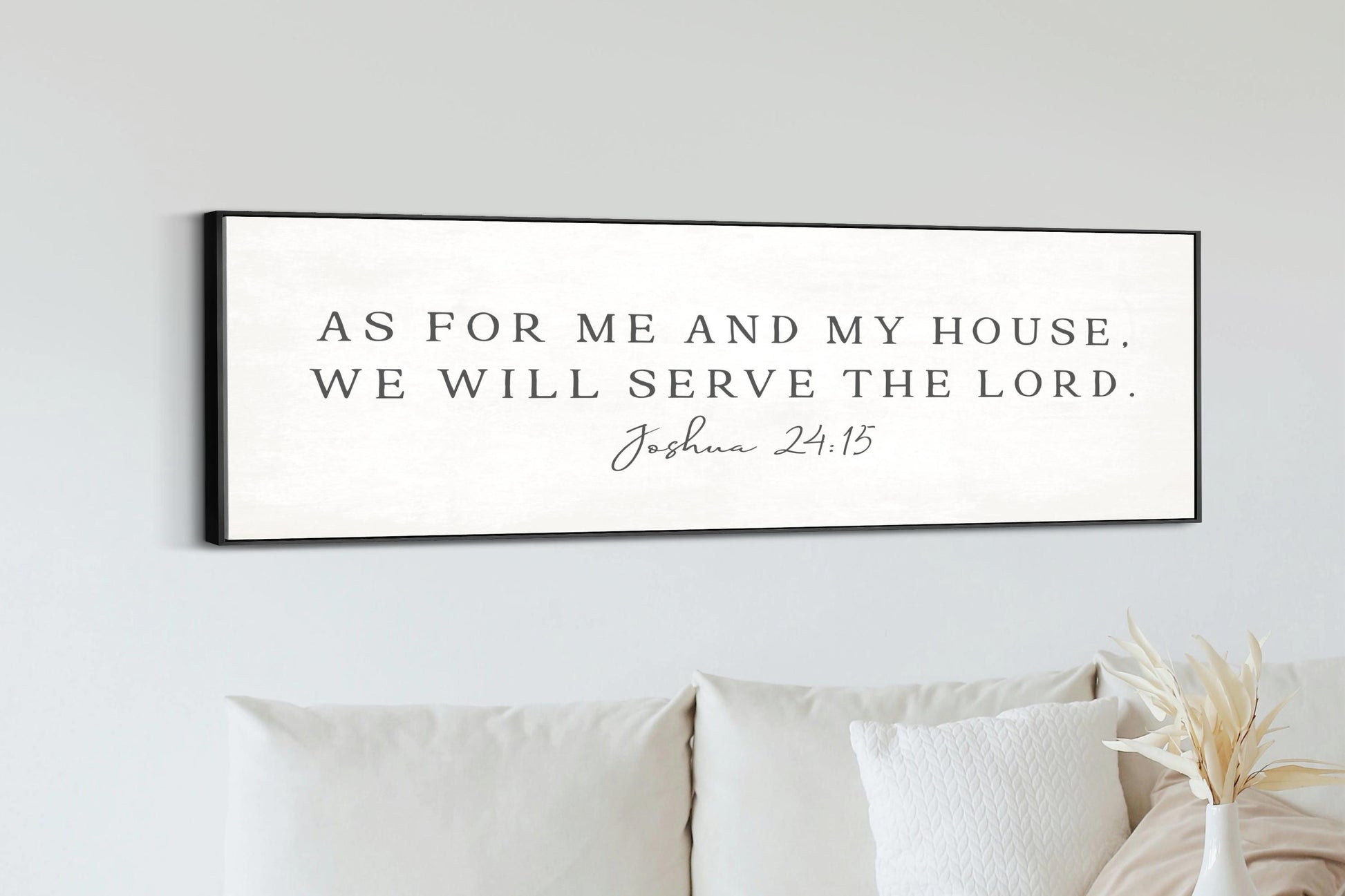 a black and white sign with the text "As for me and my house, we will serve the Lord" and the Bible verse " Joshua 24:15" below it.