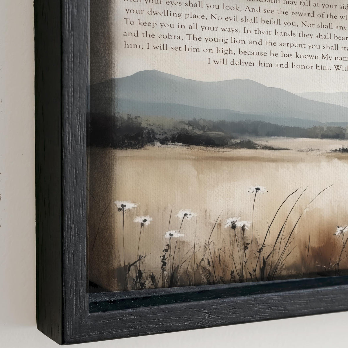 The image is a framed painting depicting a serene landscape with a field of tall grass and white flowers. The painting is framed in a black wooden frame and is hung on a wall.