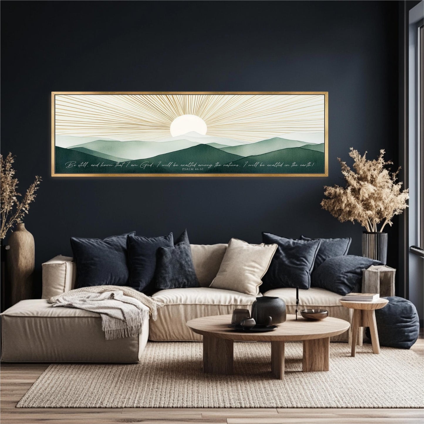 a living room with a large framed print of a serene landscape depicting a sun rising over mountains, a blue sofa with throw pillows, a wooden coffee table, and a vase of dried flowers.