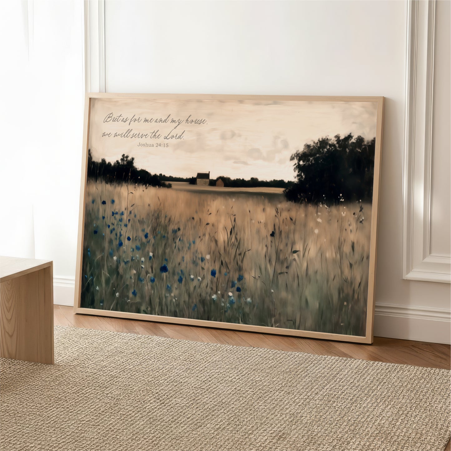 A framed painting depicting a serene landscape with a field of tall grass and trees in the background, accompanied by a Bible verse from the book of James.