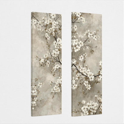 two identical paintings of white flowers on branches, displayed side by side on a wall.