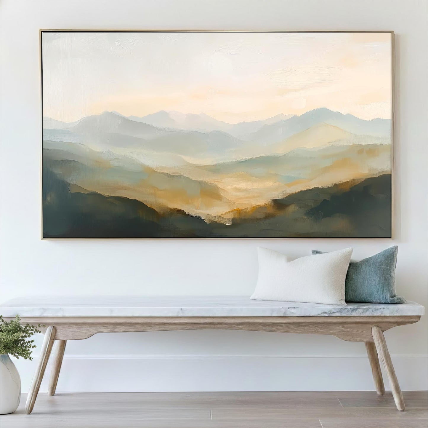 a large painting of a mountainous landscape hanging on a wall above a wooden bench with pillows.