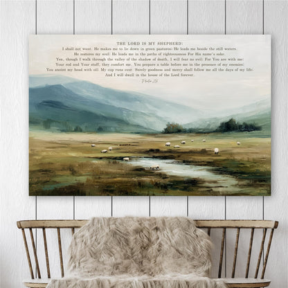 The image is a painting depicting a pastoral scene with a flock of sheep grazing in a valley, surrounded by mountains and a stream. The painting is hung on a wall above a wooden chair with a furry blanket draped over it.