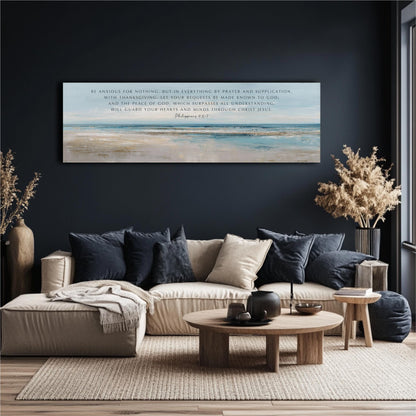 a living room with a large painting of a beach scene hanging on the wall above a beige sofa with blue throw pillows. The sofa is positioned in front of a wooden coffee table, and there are two potted plants and a vase on the floor. The overall color scheme of the room is predominantly blue and beige, creating a calm and relaxing atmosphere.