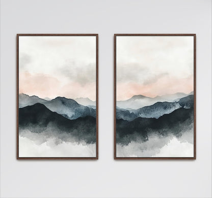 two framed watercolor paintings depicting a serene mountain landscape with a cloudy sky.