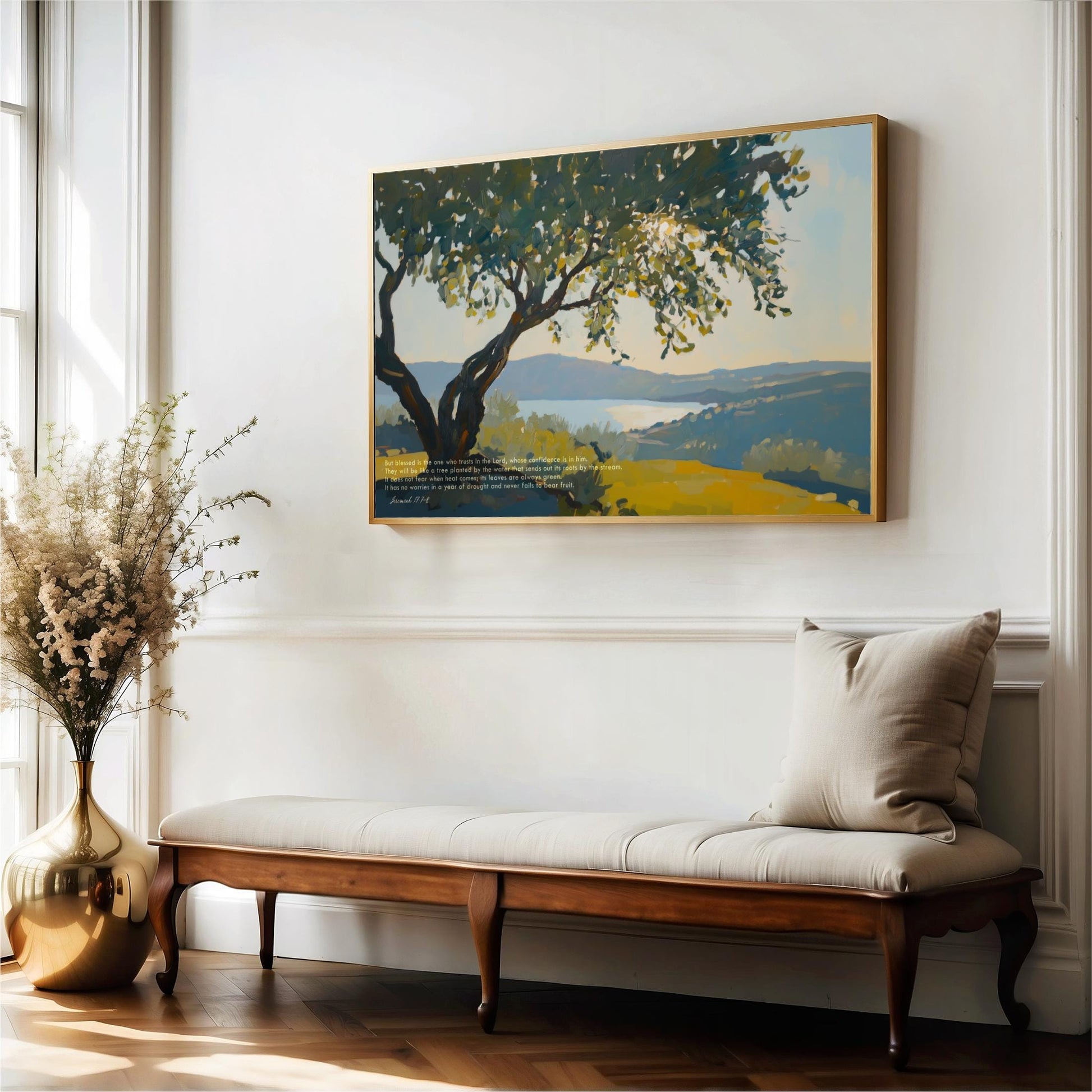 a wooden bench with a white cushion, positioned in front of a large painting depicting a serene landscape with a tree and a body of water.
