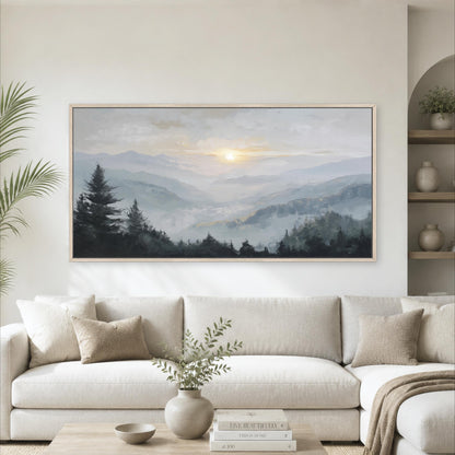 a large landscape painting hanging on a wall above a white sofa in a living room.