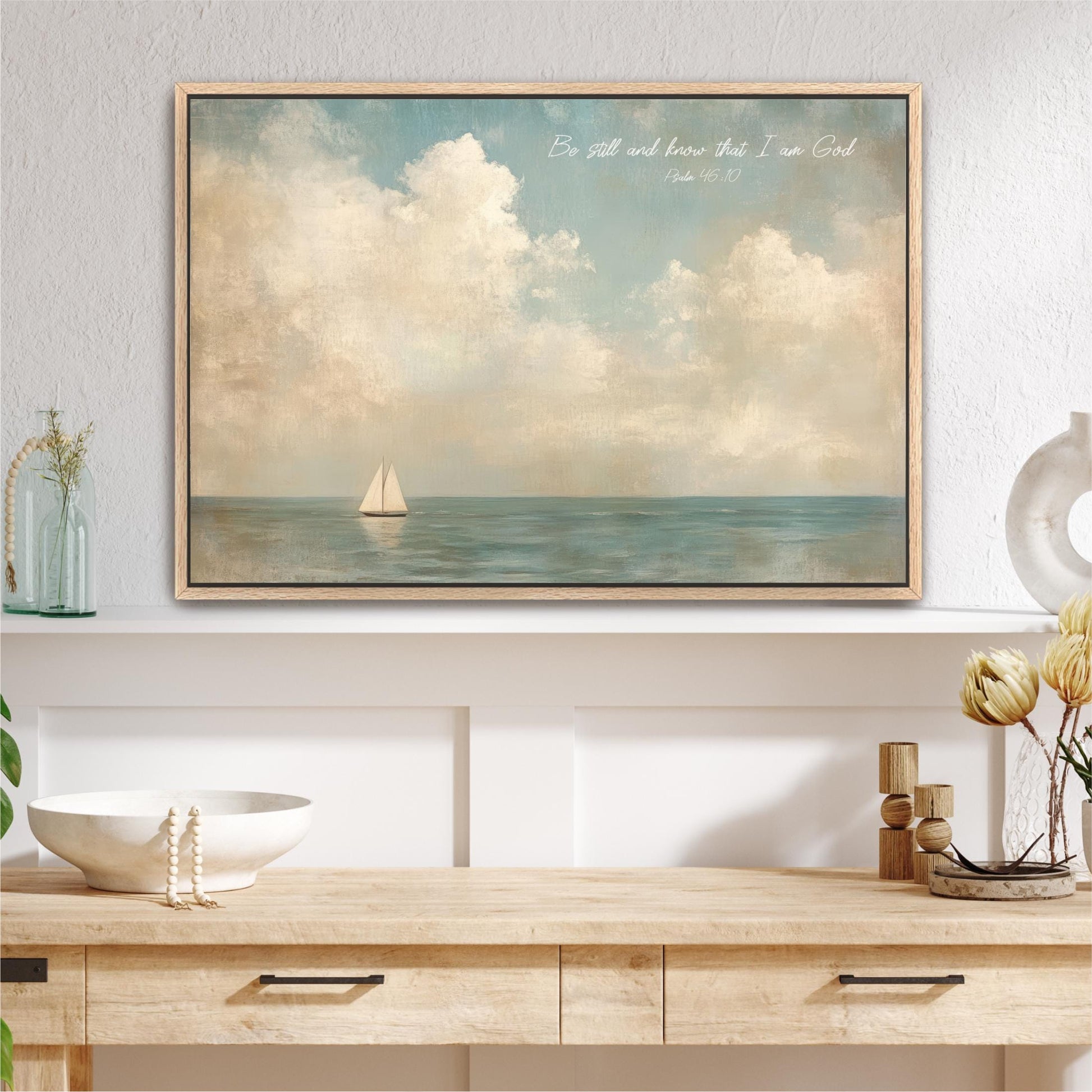 a framed painting of a sailboat on the ocean, with a wooden shelf below it and various decorative items on the shelf.