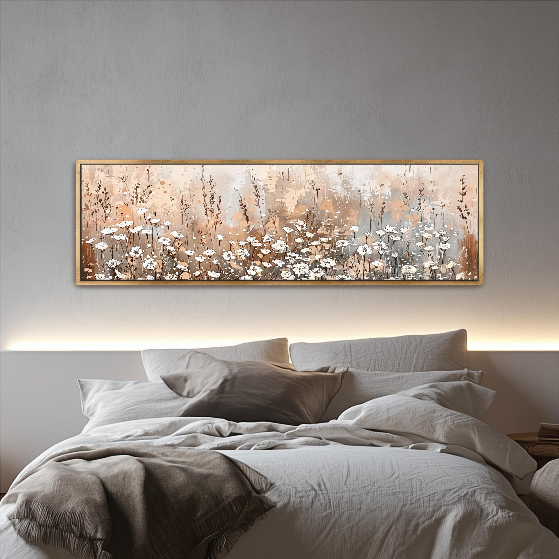 a large, framed painting of a field of flowers hanging above a bed with white bedding.